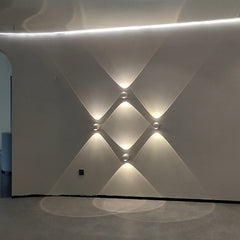 White wall with geometric light patterns
