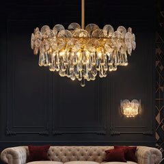 Luxurious chandelier hanging above a sofa with a dark wall background