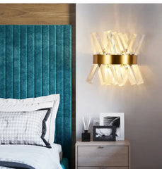 Modern bedroom with teal headboard, wall sconce, and nightstand.