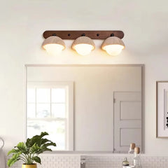 “Travertine-look wall light fixture with three dome shades for even illumination.”