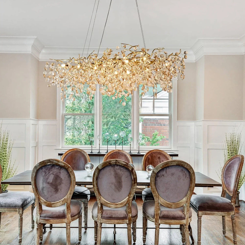 Dining room with a large chandelier, table, and chairs.