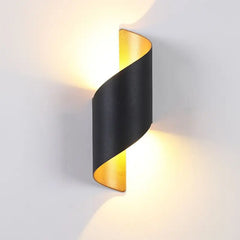“Modern decorative wall sconce with dual-beam illumination on white wall.”
