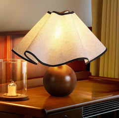 “Modern wood touch table lamp with sculpted base and fabric shade”