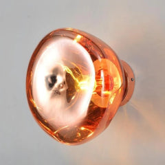 Copper wall light fixture on a neutral background; contemporary sculptural wall lamp,  for artful home lighting.