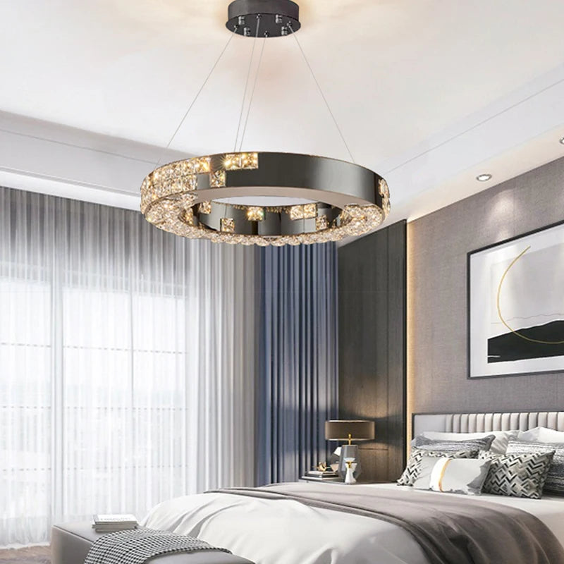 Modern bedroom with a chandelier, bed, and wall art.