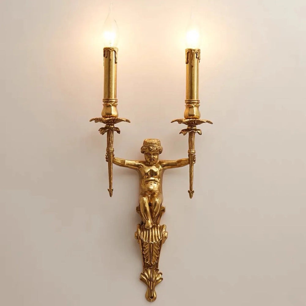 Gold wall sconce with classical design on a light background