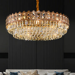 Luxurious crystal chandelier hanging above a sofa with a dark background