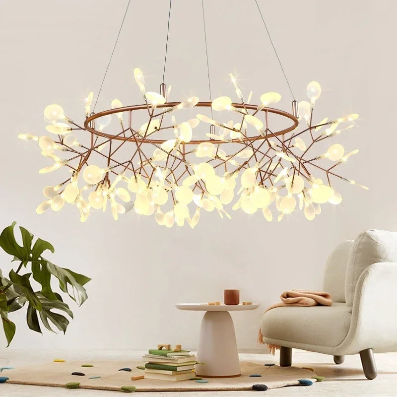Modern chandelier hanging in a living room with a plant and armchair.