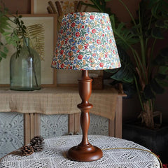 “Nordic floral bedside light on hand-turned wood base for cozy décor”