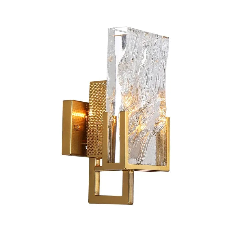 Decorative wall sconce with gold frame and textured glass on a white background