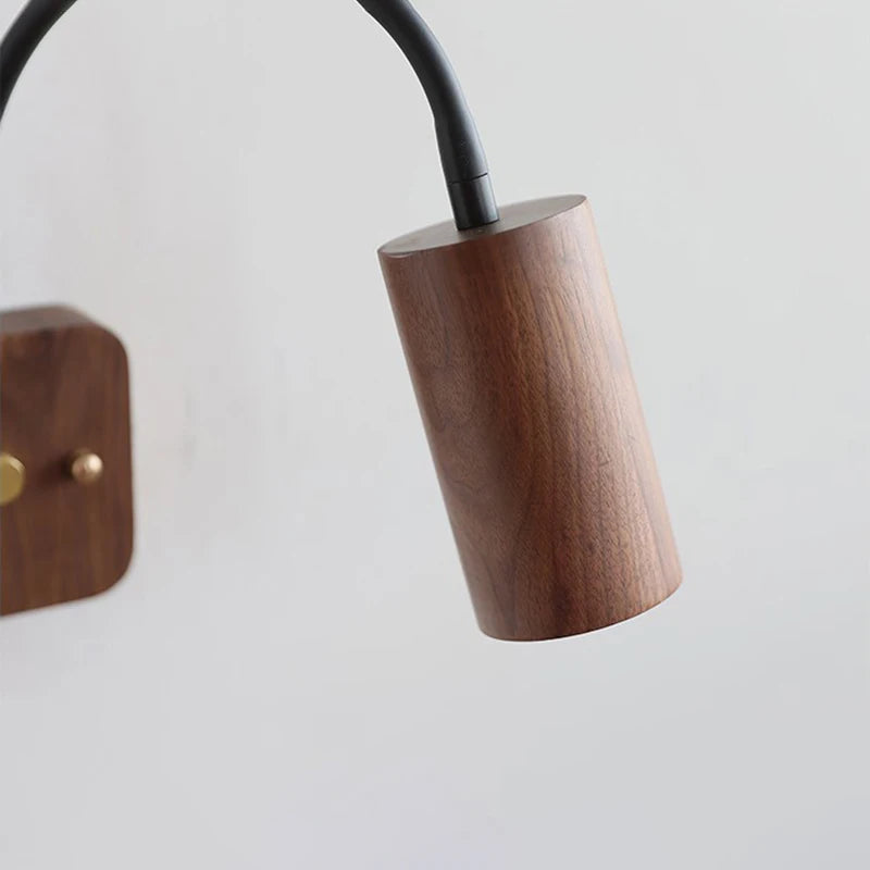 Wooden lamp base with black cord on a light gray background