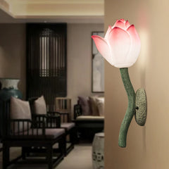 Wall-mounted lamp shaped like a pink tulip in a living room setting