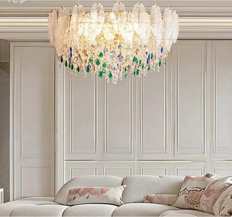 Luxurious chandelier hanging above a sofa in a stylish room with paneled walls.
