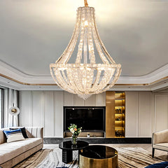 Polished steel chandelier with sparkling crystal shades as a centrepiece above plush seating