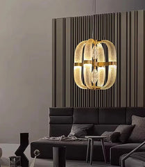 Polished steel chandelier with unique glass shapes illuminating a luxury corridor

