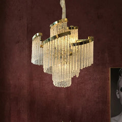 “Statement ceiling chandelier casting a warm glow in an elegant living room interior.”
