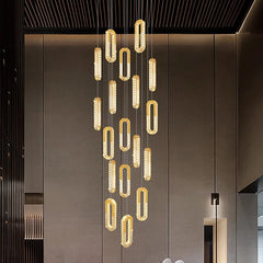 Modern chandelier hanging from the ceiling in a stylish interior setting.