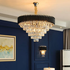 Luxurious chandelier hanging in a room with blue walls and framed artwork.