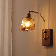 Wall-mounted lamp with glass shade and wooden base on a neutral background