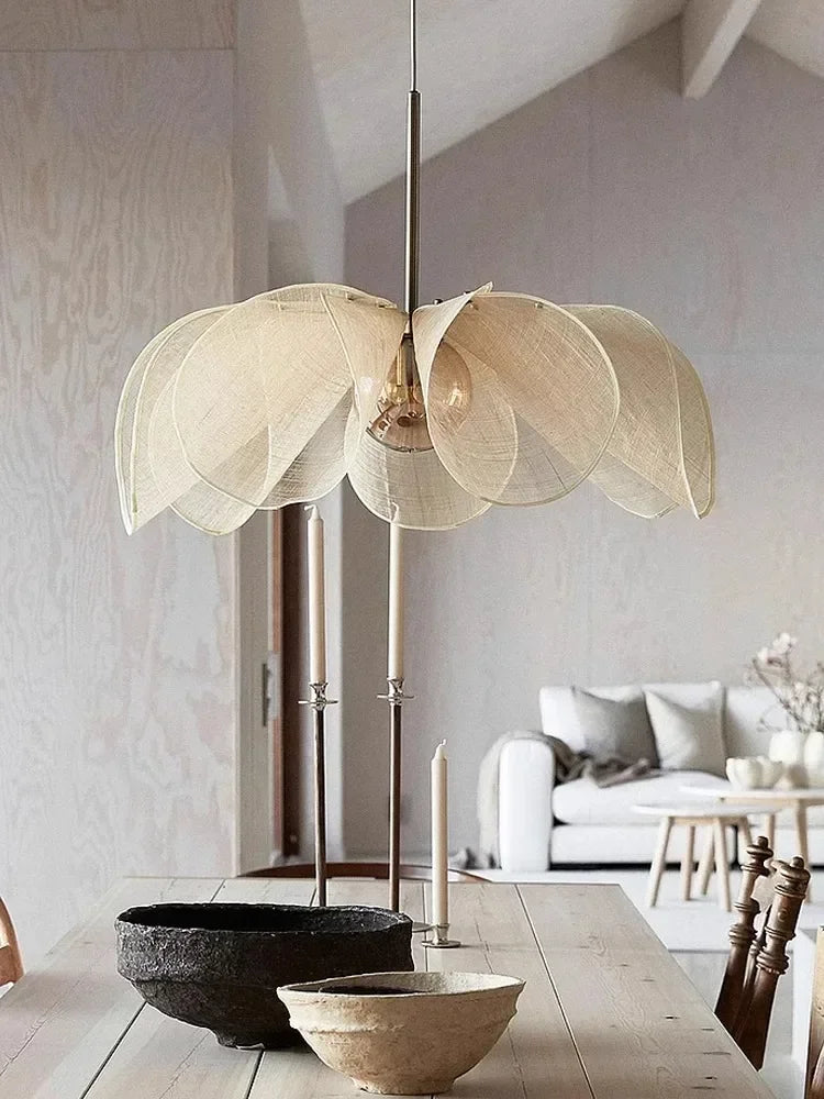 Modern pendant light fixture in a living room setting with neutral decor. Scandinavian petal ceiling lamp with E27 LED in soft beige.