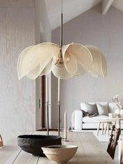 Modern pendant light fixture in a living room setting with neutral decor. Scandinavian petal ceiling lamp with E27 LED in soft beige.