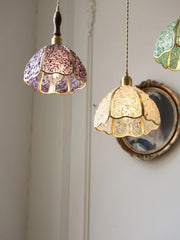 Two decorative pendant lights hang against a neutral wall—a hand-laid green crystal glass ceiling light, energy-saving, creative home lighting.