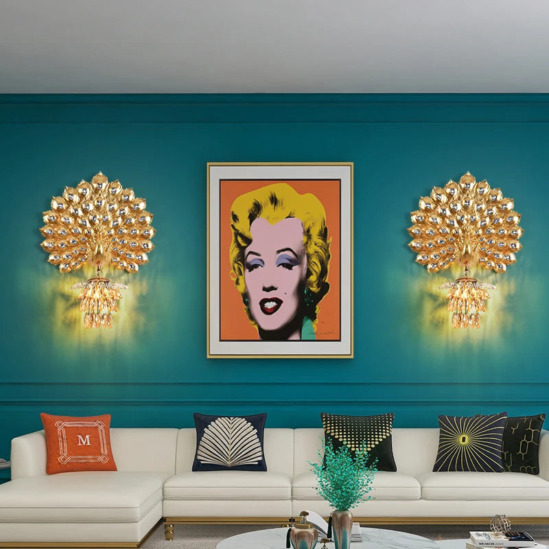 Modern living room with teal walls, gold wall sconces, and a framed portrait of a famous actress.