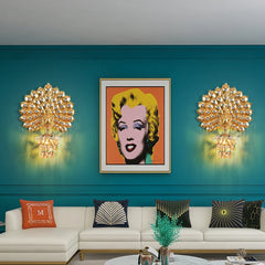 Modern living room with teal walls, gold wall sconces, and a framed portrait of a famous actress.