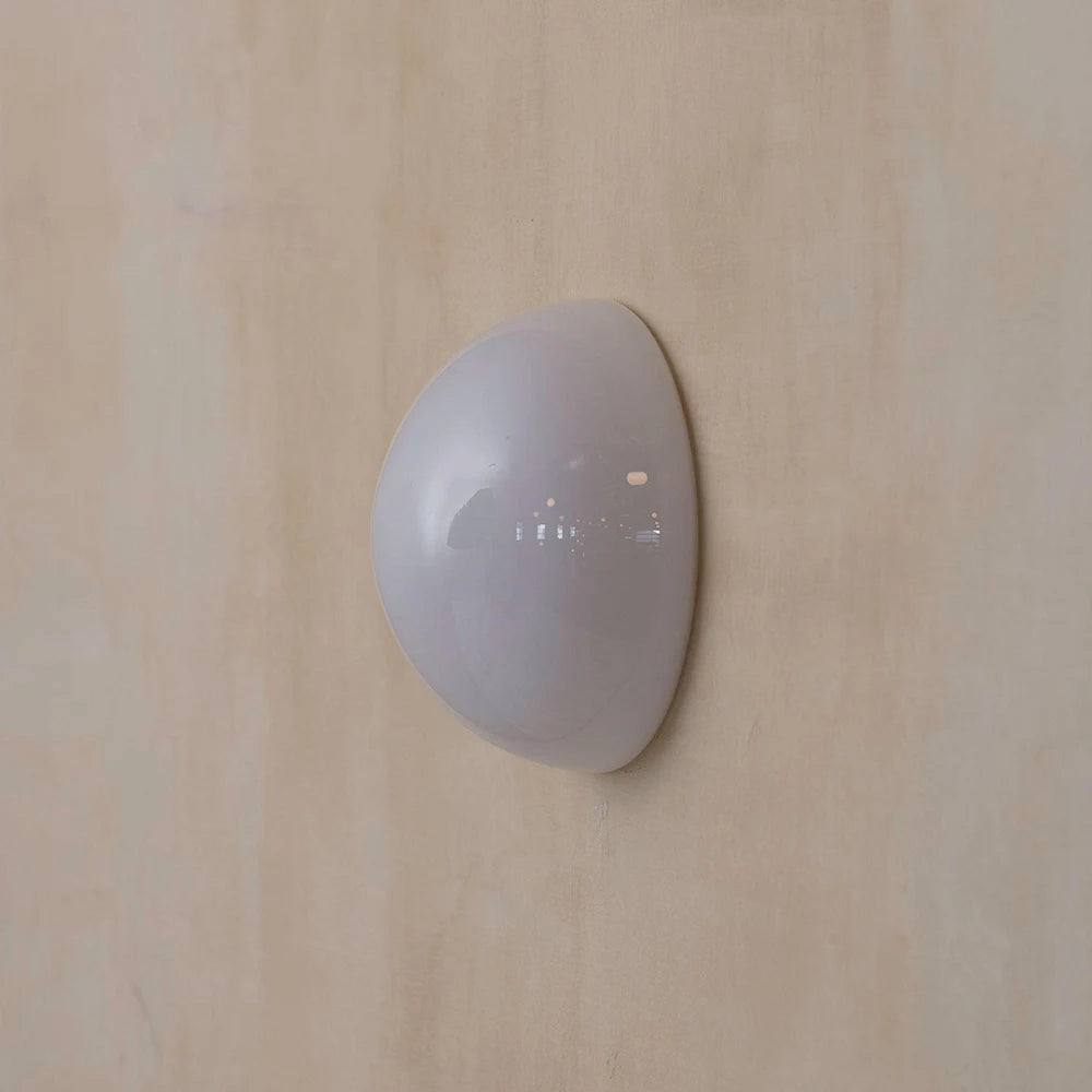 White wall-mounted device on a beige wall