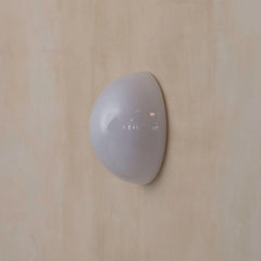 White wall-mounted device on a beige wall