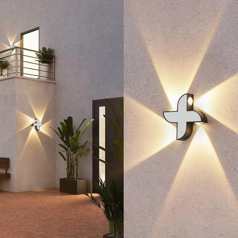 “Decorative geometric wall lamp illuminating a villa garden exterior.”