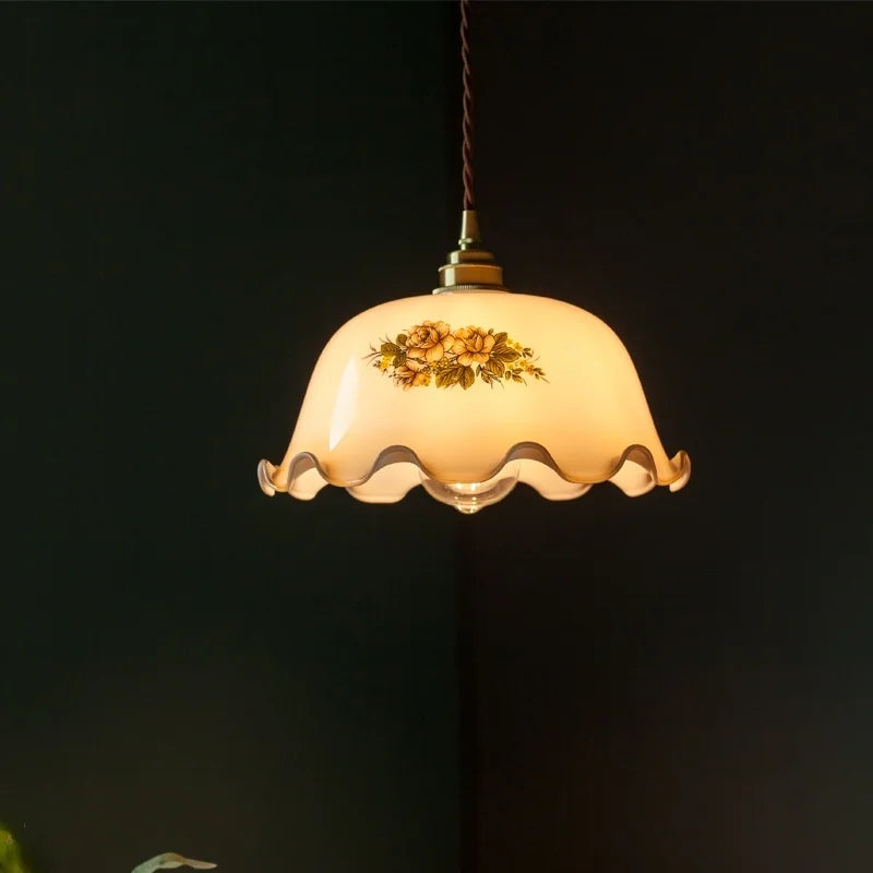 Decorative pendant light with floral design on a dark background . Vintage cream glass ceiling lamp for dining rooms and bars.