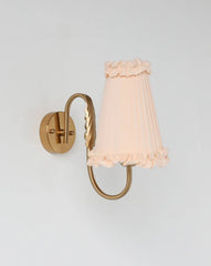 Vintage brass wall light with soft-glow pleated lampshade for elegant interiors