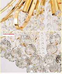 Close-up of a gold chandelier with crystal-like beads on a white background. Elegant vintage modern gold and crystal chandelier centerpiece