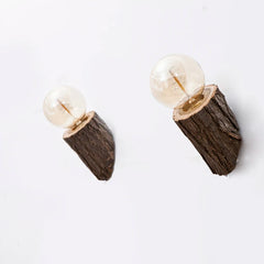 Pair of earrings with wooden base and glass ball on a white background