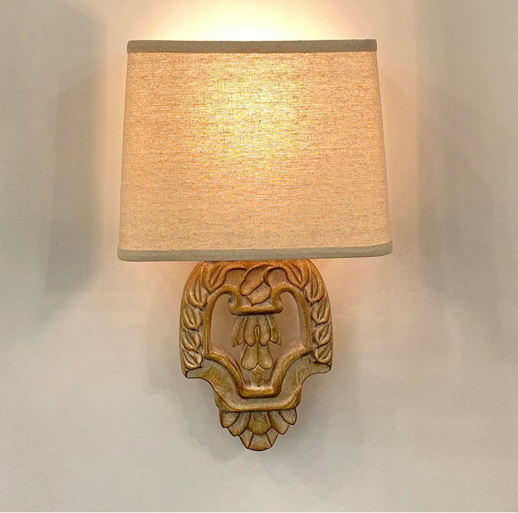 “Vintage wooden wall lamp with fabric shade in a cozy bedroom”