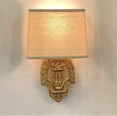 “Vintage wooden wall lamp with fabric shade in a cozy bedroom”