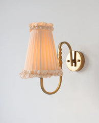 Warm ambient wall sconce with tassel-trim shade for bedroom or hallway lighting
